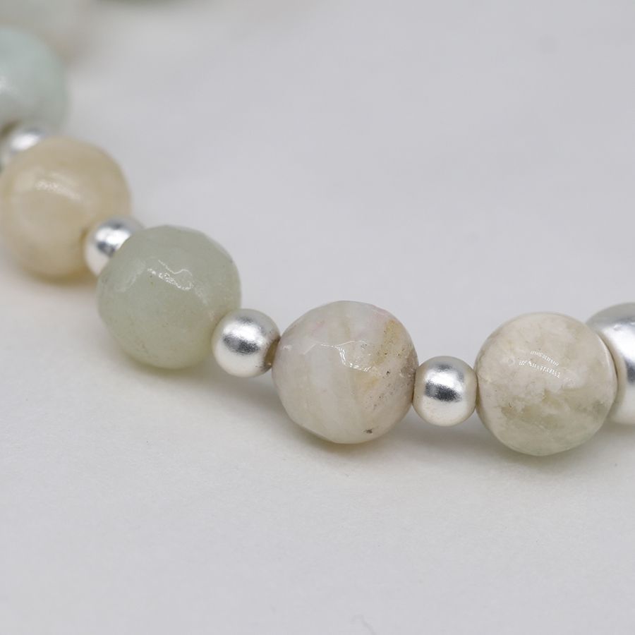 Pale natural stone bracelet with connected silver plated discs