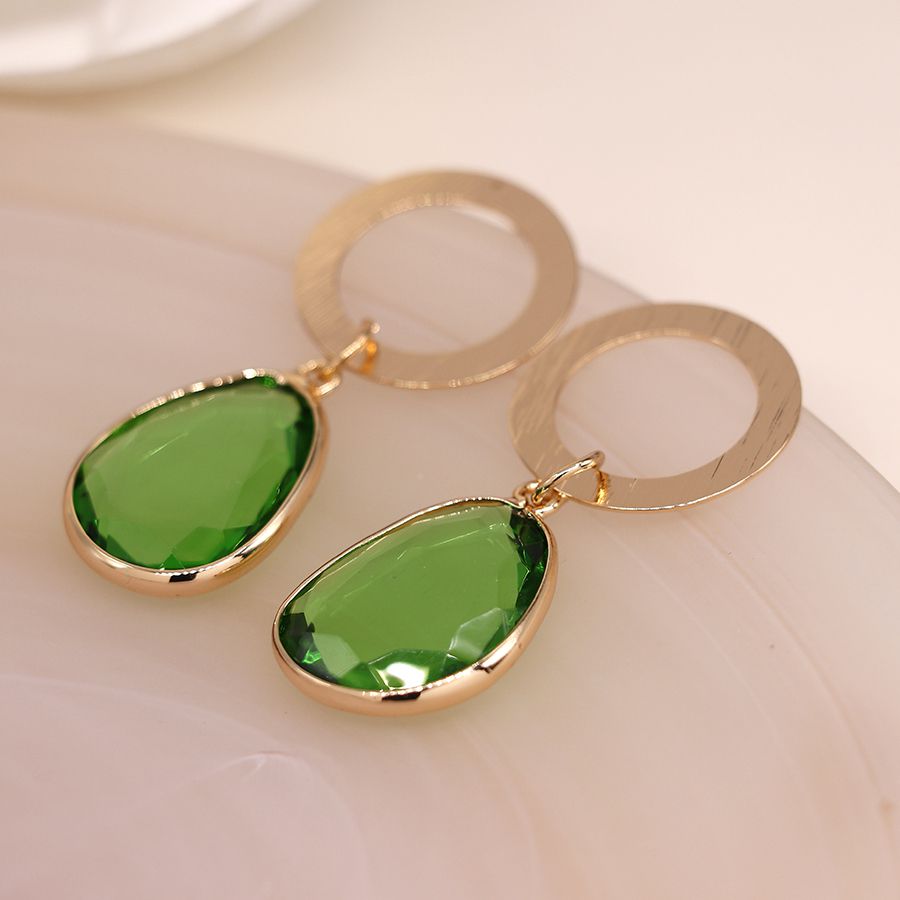 Golden scratched circle and green drop earrings