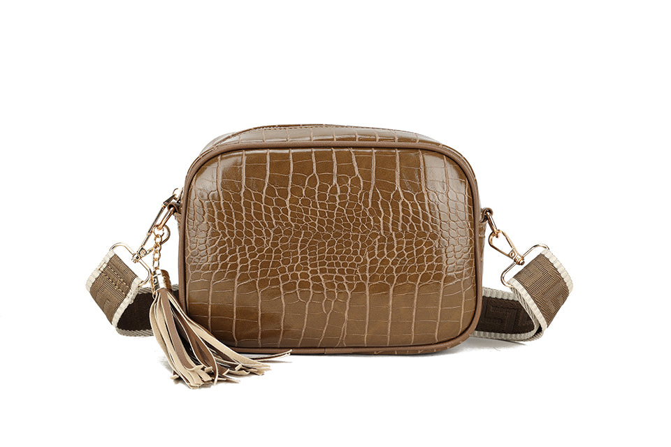 Patent cross body with patterned strap
