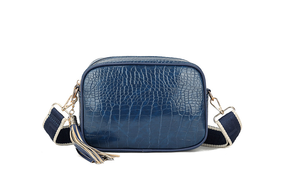 Patent cross body with patterned strap