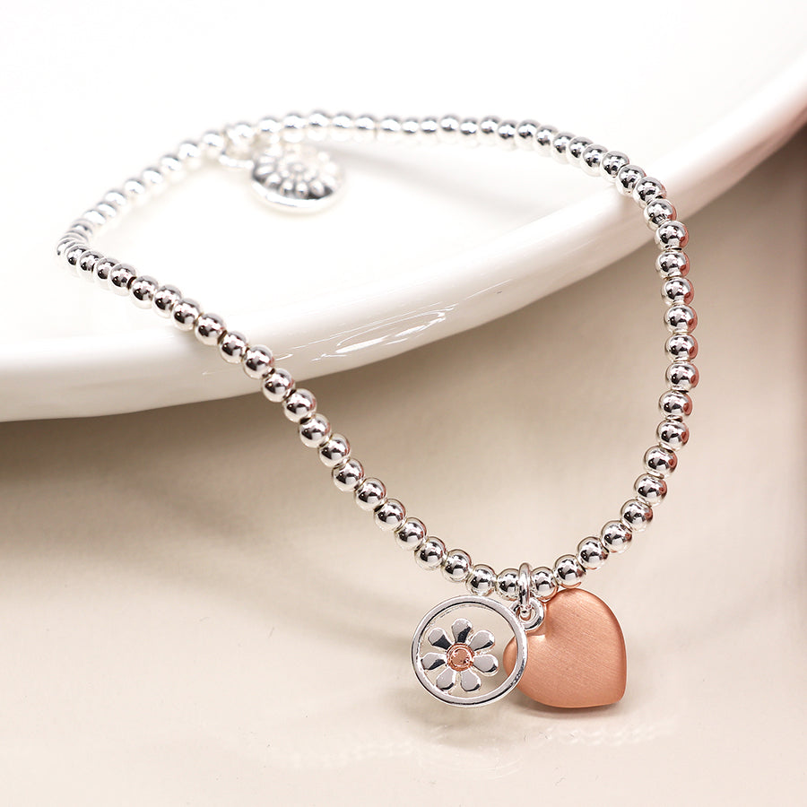 Silver plated stretch bracelet with daisy and heart charms