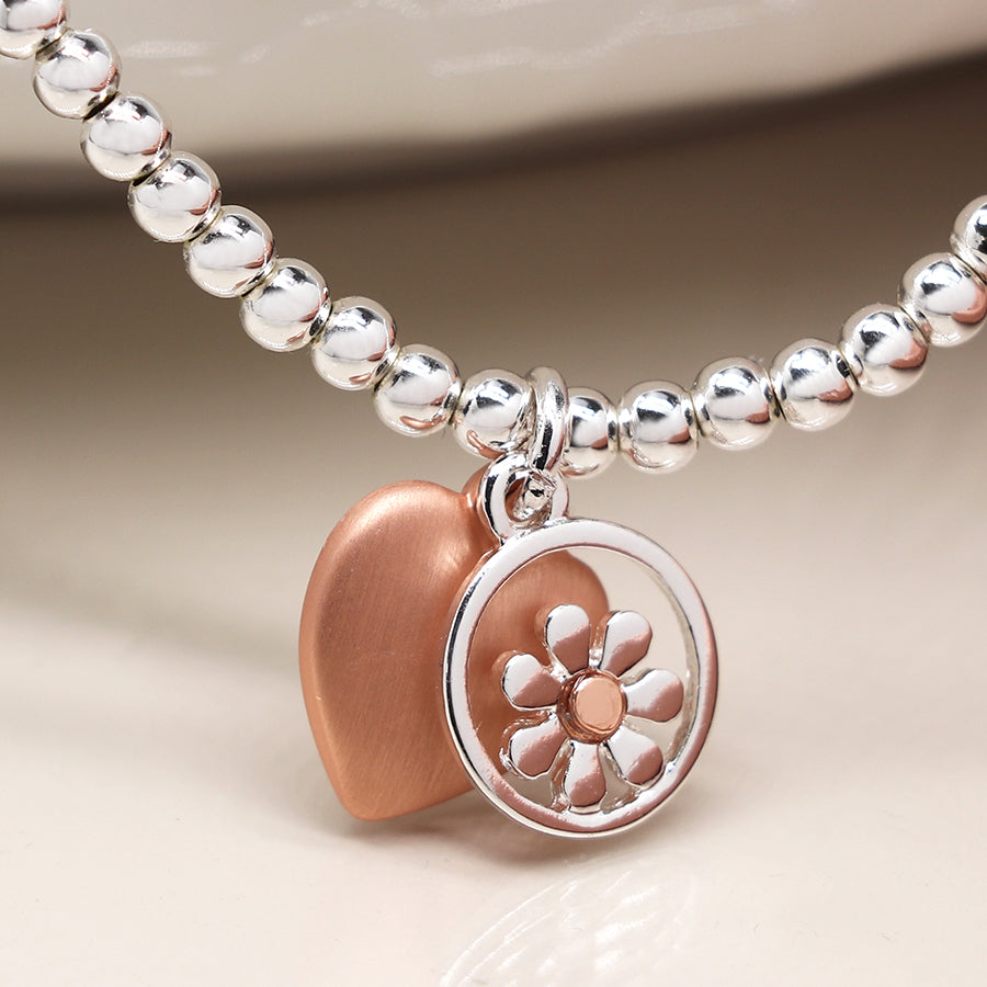 Silver plated stretch bracelet with daisy and heart charms