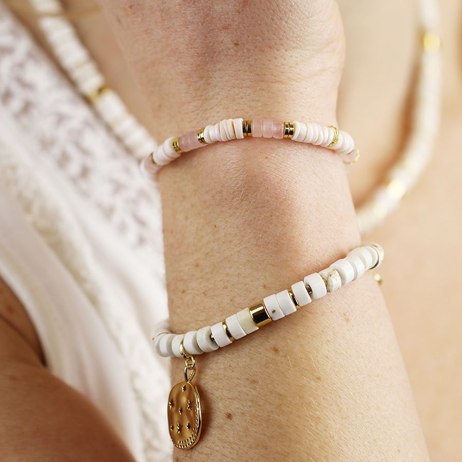 White bead bracelet with golden star disc charm