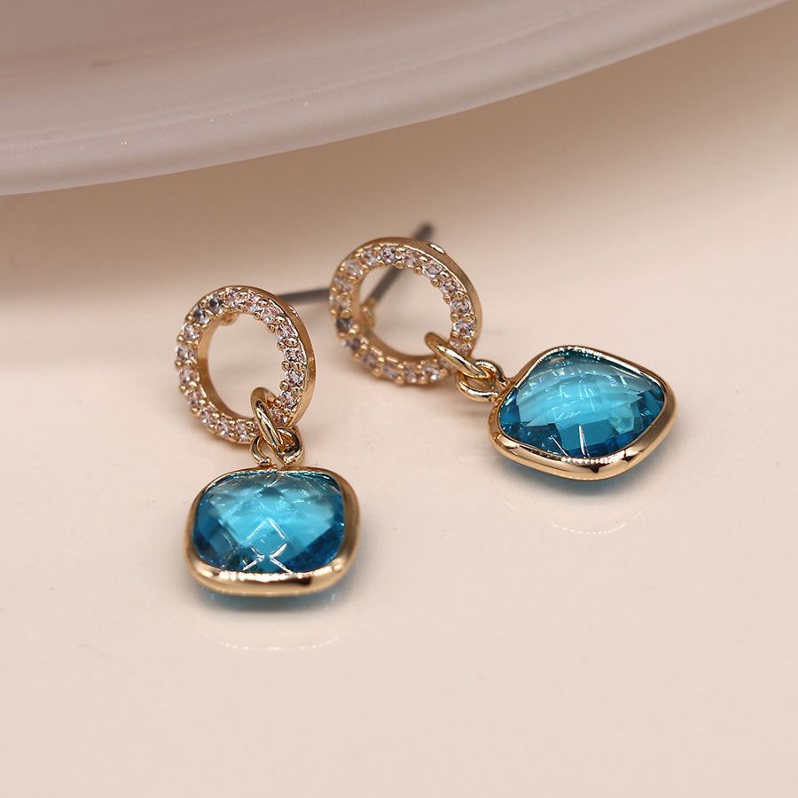 Faux gold plated crystal inset circle stud earrings with blue crystal square drops