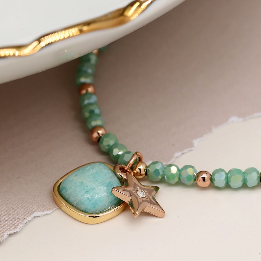 Sea green and golden charm bracelet with star and stone