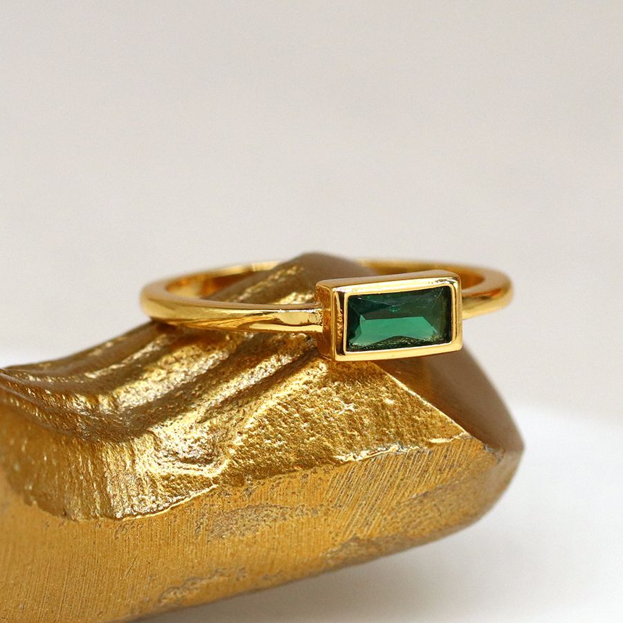 Gold plated fine band ring with a rectangular emerald green glass crystal in a gold plated setting – Medium/Large