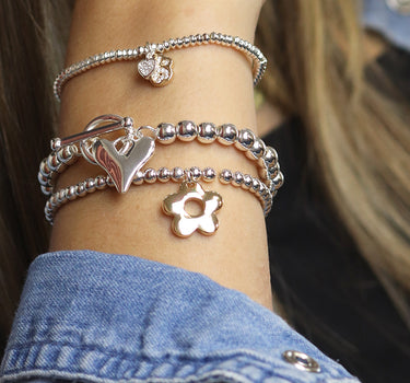 Silver plated and faux gold retro daisy charm bracelet