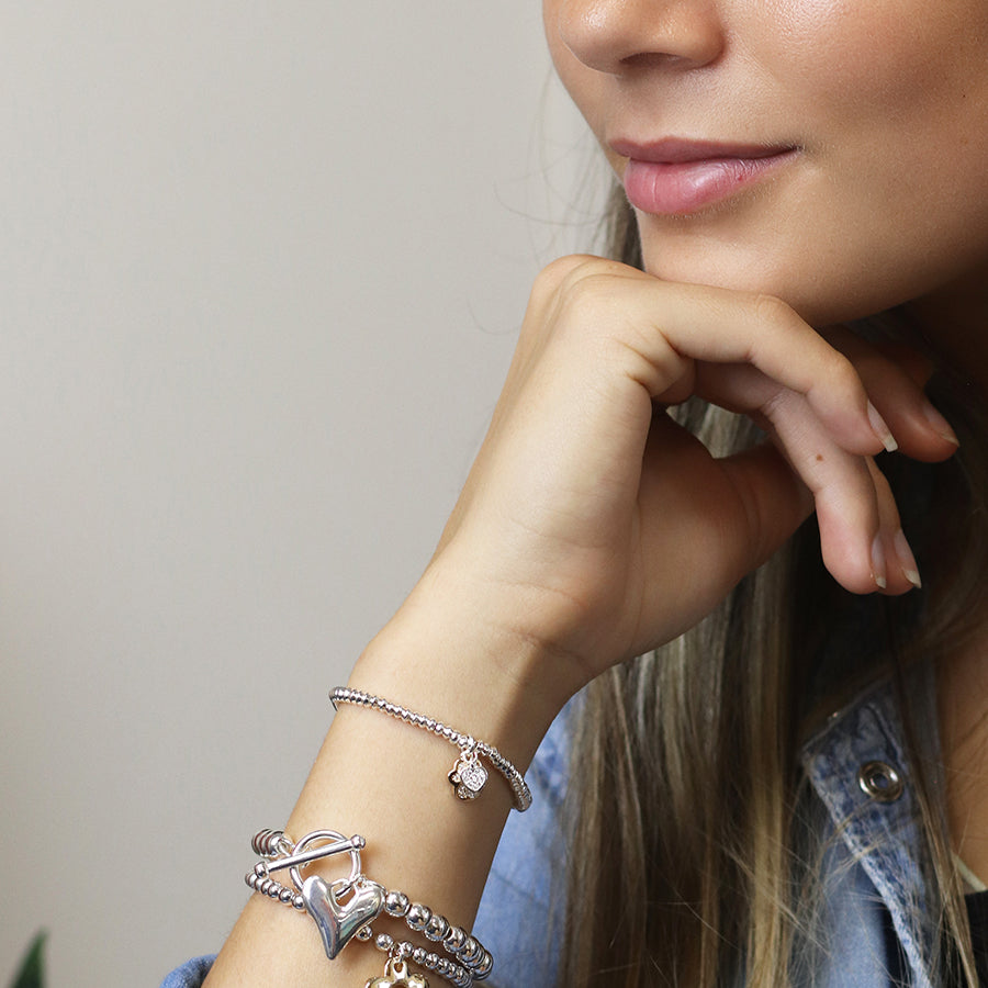 Silver plated crystal heart and golden paw charm bracelet