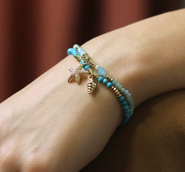 Golden shell charm and turquoise bead bracelet