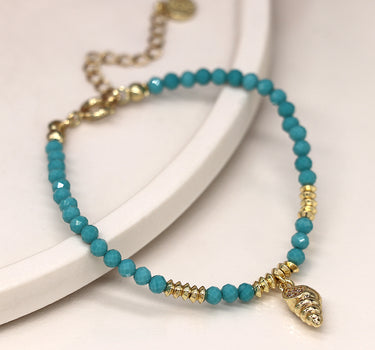 Golden shell charm and turquoise bead bracelet