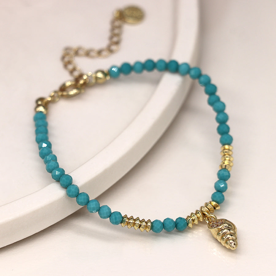 Golden shell charm and turquoise bead bracelet