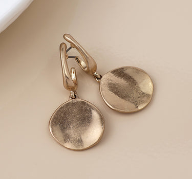 Golden worn disc drop earrings