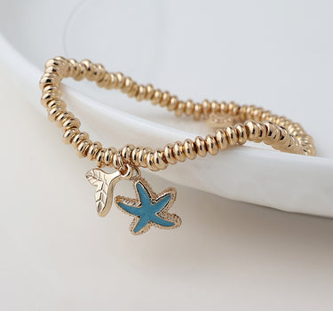Golden whale tail and blue starfish charm bracelet
