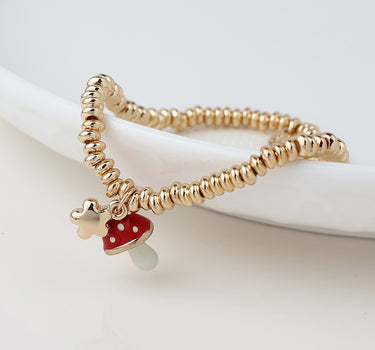 Golden flower and toadstool charm bracelet
