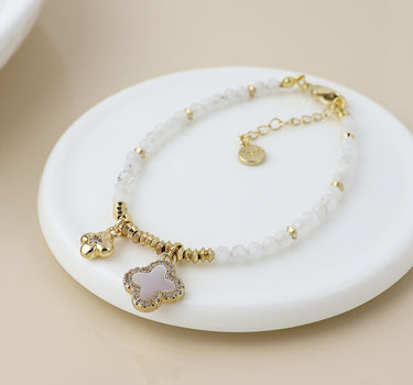 Golden and white bead quatrefoil charm bracelet