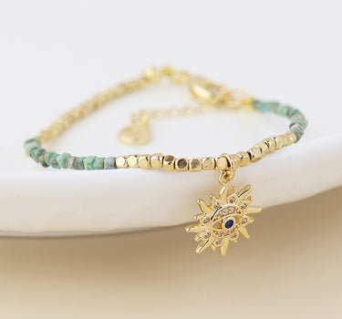 Golden and turquoise bracelet with crystal sun charm